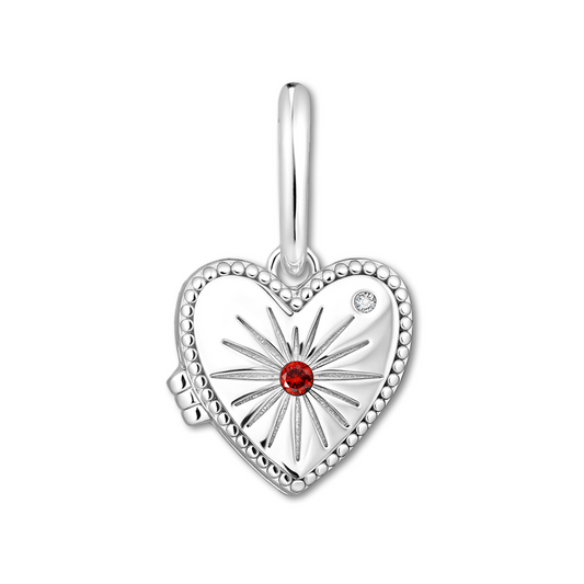 Silver heart-shaped locket with a red gemstone on a white background